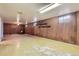 Spacious basement with wood paneling and vinyl flooring at 1750 S Dale Ct, Denver, CO 80219