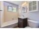 Bathroom with a shower-tub combo and vanity with storage at 1750 S Dale Ct, Denver, CO 80219