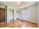 A bedroom with hardwood floors, built-in closets, and a window at 1750 S Dale Ct, Denver, CO 80219