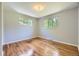 Comfortable bedroom with hardwood floors and natural light from two windows at 1750 S Dale Ct, Denver, CO 80219
