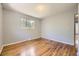Bedroom features hardwood floors and a window providing natural light at 1750 S Dale Ct, Denver, CO 80219