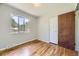 A bedroom with hardwood floors, a closet and a window at 1750 S Dale Ct, Denver, CO 80219