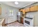 Functional kitchen with stainless steel refrigerator and traditional appliances at 1750 S Dale Ct, Denver, CO 80219