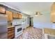 Practical kitchen with ample counter space, wood cabinets and traditional appliances at 1750 S Dale Ct, Denver, CO 80219