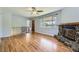 Open living room with hardwood floors and a stone fireplace at 1750 S Dale Ct, Denver, CO 80219