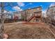 Backyard with mulched area, hot tub, and deck with string lights at 6193 Brantly Ave, Castle Rock, CO 80104