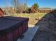 Backyard featuring a hot tub, fire pit, playground, and grass at 6193 Brantly Ave, Castle Rock, CO 80104