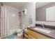 Bathroom featuring a shower over the tub, toilet, sink, and mirror at 6193 Brantly Ave, Castle Rock, CO 80104