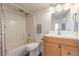 A clean bathroom featuring a tub/shower, light wood vanity, and a large mirror at 6193 Brantly Ave, Castle Rock, CO 80104