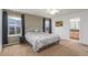 Bright bedroom featuring a queen bed with floral bedding, neutral walls, and plush carpet at 6193 Brantly Ave, Castle Rock, CO 80104