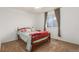 A bedroom features a simple bed and a view from the window at 6193 Brantly Ave, Castle Rock, CO 80104