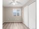 Minimalist bedroom with wood-look floors, a window with views, and a sliding door closet at 6193 Brantly Ave, Castle Rock, CO 80104