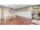 Dining area with wood floors and an accent wall, located just off of the living room at 6193 Brantly Ave, Castle Rock, CO 80104