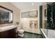 Elegant bathroom featuring green marble tile, a sleek vanity, and a walk-in shower at 300 W 11Th Ave # 15F, Denver, CO 80204