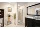 Bright bathroom featuring a glass shower, modern vanity with granite counters and decorative accents at 300 W 11Th Ave # 15F, Denver, CO 80204