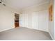 Empty bedroom featuring neutral carpet, double door closet, and ample natural light at 300 W 11Th Ave # 15F, Denver, CO 80204