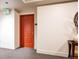 Hallway featuring a vibrant red entrance door, neutral walls, and contemporary decor at 300 W 11Th Ave # 15F, Denver, CO 80204