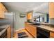 Updated kitchen featuring granite counters, stainless appliances, and wood cabinets at 300 W 11Th Ave # 15F, Denver, CO 80204