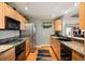 Modern kitchen with stainless steel appliances, granite countertops, and wood cabinets at 300 W 11Th Ave # 15F, Denver, CO 80204