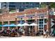 Outdoor dining area with Levain Deli and Purveyors storefront, inviting atmosphere at 300 W 11Th Ave # 15F, Denver, CO 80204