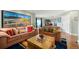 Comfortable living room with plush sofas, wooden accents, and a view into the dining area at 300 W 11Th Ave # 15F, Denver, CO 80204