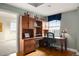 Cozy home office featuring custom built-ins, wood floors, and a large window for natural light at 300 W 11Th Ave # 15F, Denver, CO 80204