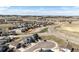 Wide aerial view of a community showcasing numerous homes, paved streets, and open spaces at 929 Honey Berry Ct, Elizabeth, CO 80107