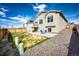 Spacious fenced backyard featuring a deck, patio, and rock landscaping at 929 Honey Berry Ct, Elizabeth, CO 80107
