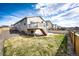Beautiful backyard with a wooden fence, green grass, deck, patio, and some landscaping at 929 Honey Berry Ct, Elizabeth, CO 80107