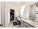Bathroom featuring dual vanities with granite countertops and walk in closet at 929 Honey Berry Ct, Elizabeth, CO 80107