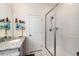 Bathroom showcasing a glass-enclosed shower and stylish vanity with granite counters at 929 Honey Berry Ct, Elizabeth, CO 80107