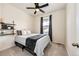 Neutral-toned bedroom featuring a ceiling fan and a decorative shelving unit at 929 Honey Berry Ct, Elizabeth, CO 80107