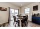 Bright dining area with wood floors, sliding glass doors, and a coffee bar at 929 Honey Berry Ct, Elizabeth, CO 80107