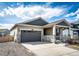 Single Gathering home showcasing a two-car garage, neutral siding, and a welcoming covered porch at 929 Honey Berry Ct, Elizabeth, CO 80107