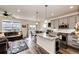 Bright and airy kitchen with a center island, stainless steel appliances, open to a living area at 929 Honey Berry Ct, Elizabeth, CO 80107