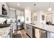 Modern kitchen with stainless steel appliances, granite countertops, and gray cabinetry at 929 Honey Berry Ct, Elizabeth, CO 80107