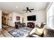 Cozy living room with a ceiling fan, TV, and comfortable seating on a stylish rug at 929 Honey Berry Ct, Elizabeth, CO 80107