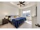 Bright main bedroom with tray ceilings and large windows showing neighborhood views at 929 Honey Berry Ct, Elizabeth, CO 80107