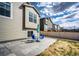 Stone patio with dining set and umbrella in a fully fenced backyard at 929 Honey Berry Ct, Elizabeth, CO 80107