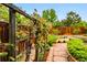 Lush backyard with a garden featuring a grape vine covered trellis, and well-maintained landscaping at 1205 W 11Th Ct, Broomfield, CO 80020