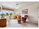 Bedroom with a ceiling fan, desk with chair, rocking chair, and window views at 1205 W 11Th Ct, Broomfield, CO 80020