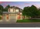 Charming two-story home boasts brick accents, a three-car garage, a manicured lawn, and inviting front porch seating at 1205 W 11Th Ct, Broomfield, CO 80020