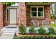 Inviting front porch with brick accents, seating, and well-landscaped garden at 1205 W 11Th Ct, Broomfield, CO 80020