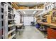 Organized garage featuring woodworking tools, workbenches, and ample storage space at 1205 W 11Th Ct, Broomfield, CO 80020