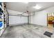 Spacious garage with a white door, storage shelves, and ample room for parking at 1205 W 11Th Ct, Broomfield, CO 80020