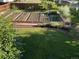 Beautiful backyard with a raised garden, lush lawn, and manicured hedges at 1205 W 11Th Ct, Broomfield, CO 80020
