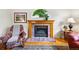 Cozy living room with a brick fireplace and comfortable seating, perfect for relaxing evenings at 1205 W 11Th Ct, Broomfield, CO 80020