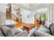 Inviting living room with hardwood floors, staircase, and entry to the dining area at 1205 W 11Th Ct, Broomfield, CO 80020