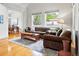 Comfortable living room featuring hardwood floors, large windows, and an archway leading to the dining area at 1205 W 11Th Ct, Broomfield, CO 80020