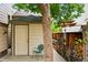 Backyard storage shed with woodpile, windchimes, and garden accents at 1205 W 11Th Ct, Broomfield, CO 80020